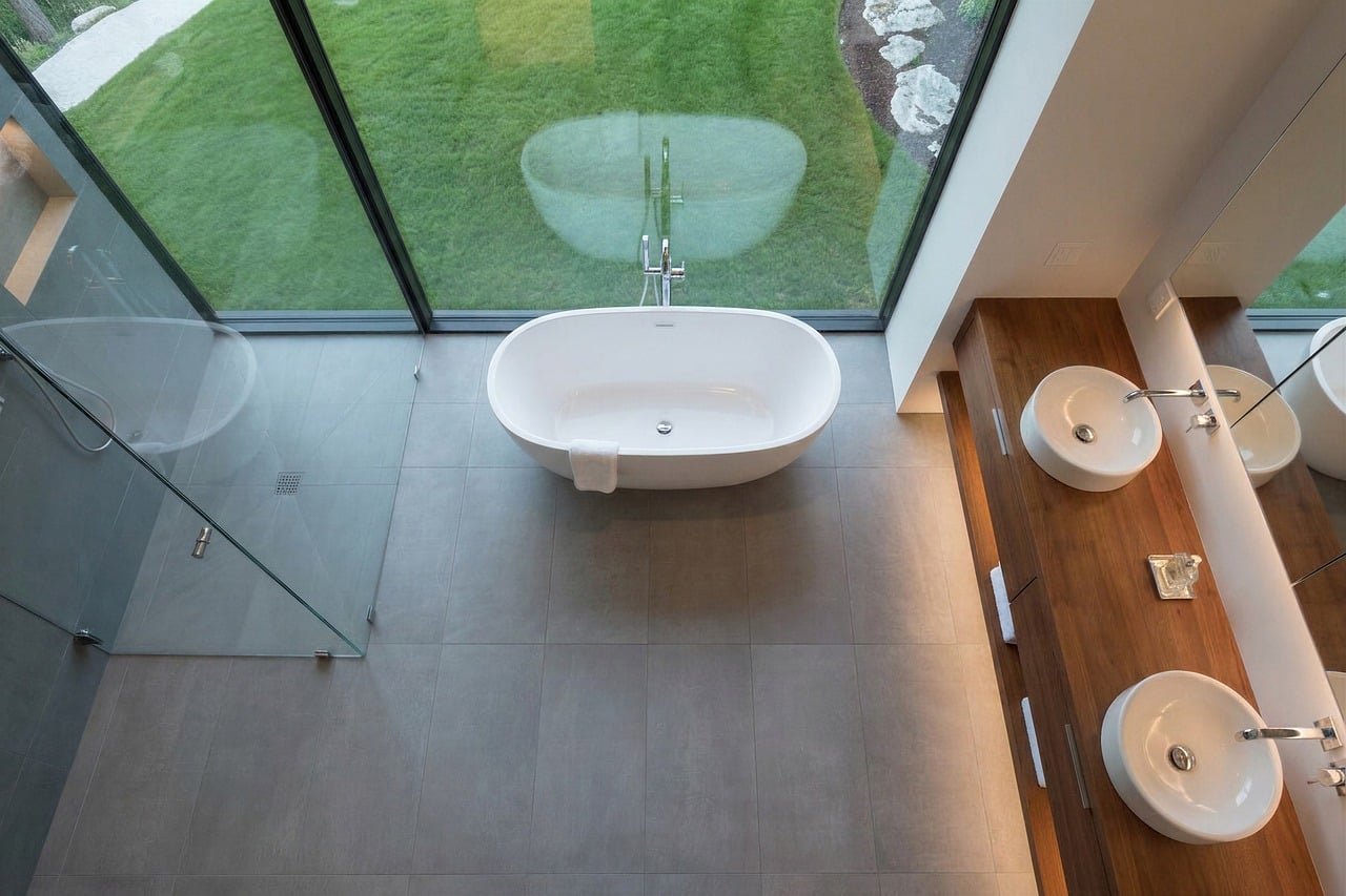 bathroom, bathtub, glass wall, modern design, wooden countertop, double sink, sink, glass shower, garden view, interior lighting, minimalist design, at home, panoramic windows, soothing atmosphere, indoor plants, warm interior, beautiful aesthetics, luxury bathroom, calm atmosphere